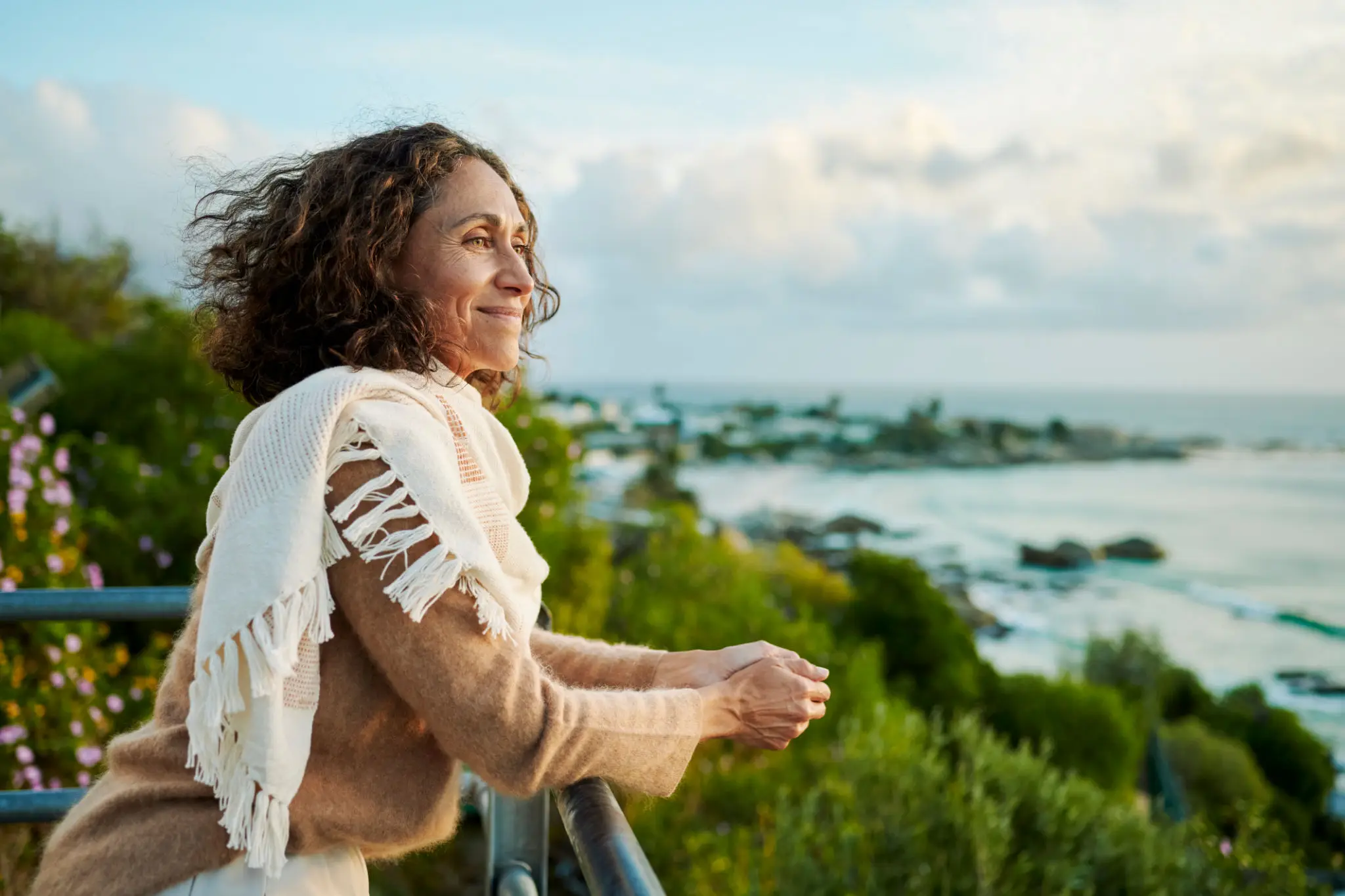 A woman enjoying a serene view of greenery and water.